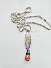 White with orange highlights ocean jasper cabochon on sterling silver chain