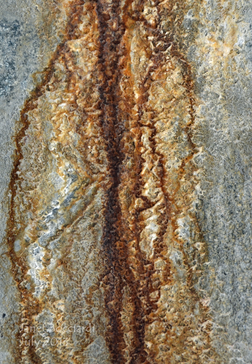 rust and water lines on rock