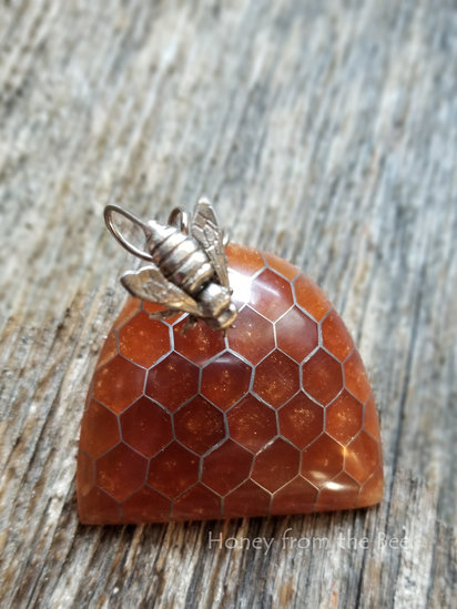 Beehive brooch features resin in aircraft aluminum, sterling silver