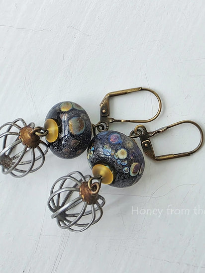 Cage Fight earrings features lampwork and vintage metal drops