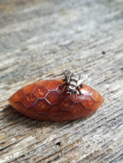 Honeycomb Brooch features resin in aircraft aluminum and sterling silver