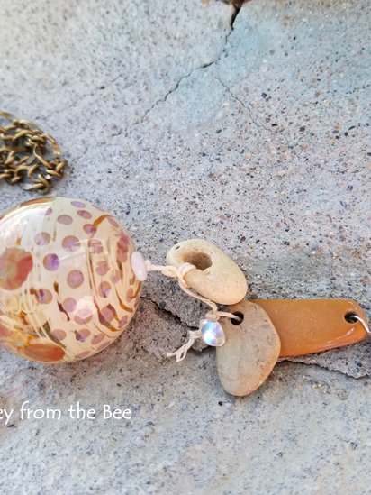 Hope Floats No 2 pendant features lampwork, hag stones, pearl