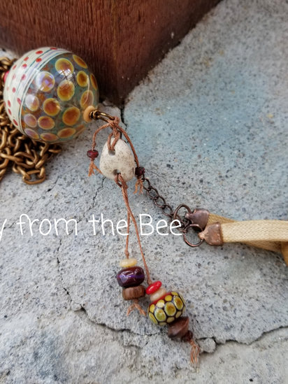 Hope Floats No 1 pendant features hag stone, lampwork