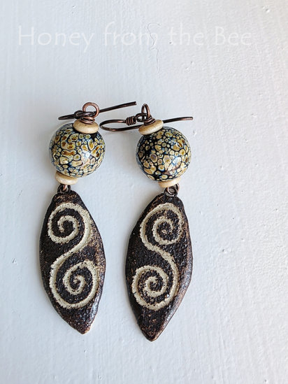 Rebirth earrings features lampwork and ceramic drops