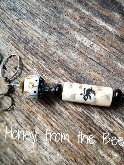 Some Bunny Loves Me necklace features chalcedony, carved bone, lampwork