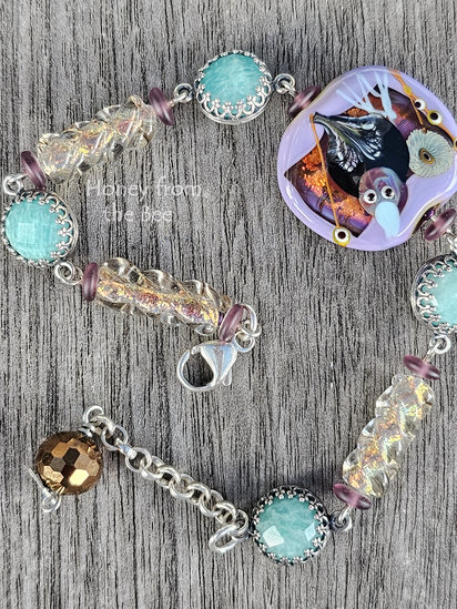 Something to Crow About bracelet features lampwork and chrysophase set in sterling silver