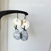 Grey and white earrings feature antique mother of pearl buttons and orbicular jasper
