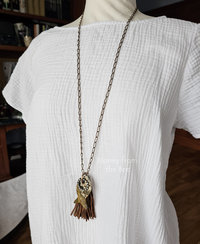 Old stock ocean jasper in shape of fish pendant on model