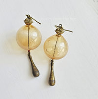 Yellow hollow bead earrings with aged brass drops