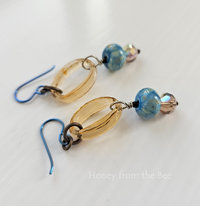 Peach and sky blue earrings feature lampwork and faceted crystals