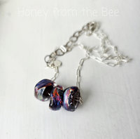 Red and blue lampwork necklace on sterling silver chain