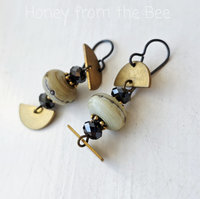 Cream and gold earrings with black