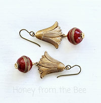 Dangle earrings feature vintage brass water lily and red lucite bead