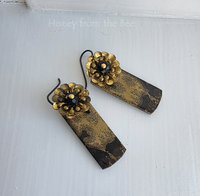Statement earrings in gold and black