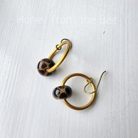 Giraffe print earrings on gold hoops