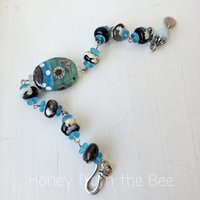 Lampwork bracelet with aquatic theme in aqua, black and cream