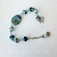 Beaded bracelet in aqua and cream and black
