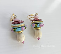 Floral earrings feature lampwork in shades of pink, aqua and gold