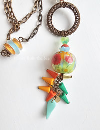 Flower themed necklace features bright colored lampwork and vintage materials.