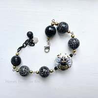 Black and white bead bracelet with honeybee focal