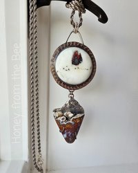 Statement necklace features plume agate and art glass