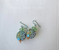 Artisan glass earrings in shades of orange, aqua and green