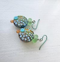 Colorful earrings in orange, green and aqua