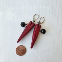 Heart earrings feature red wooden hearts and antique black button