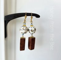Artisan earrings feature lampwork and wood dangles