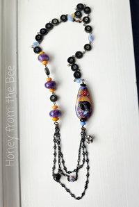 One of a kind lampwork necklace in purple, blue and orange