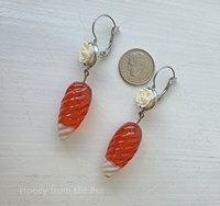 Orange and white earrings feature white rose and vintage drops