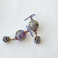Artisan earrings feature berry dangle and lampwork in purple and green