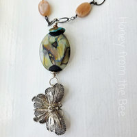 Butterfly necklace features filigree butterfly and peach moonstone