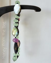 Faceted bead bracelet in grey, green, and pink