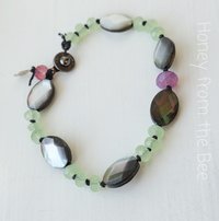 Artisan bracelet in grey, green, and pink