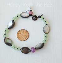 Beaded bracelet in faceted grey, green and pink beads
