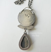 Photo shows back of artisan pendant
