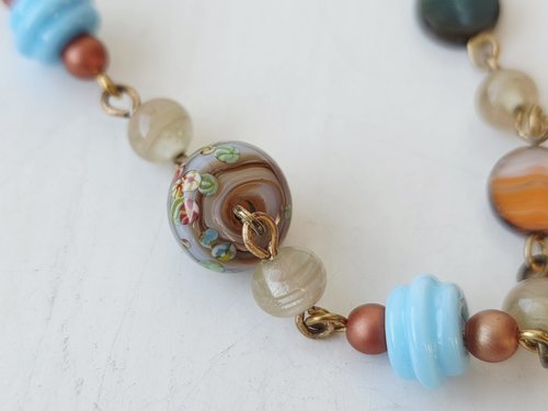 orange and blue bracelet features lampwork bead