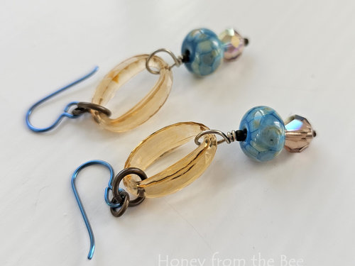 Peach and sky blue earrings feature lampwork and faceted crystals