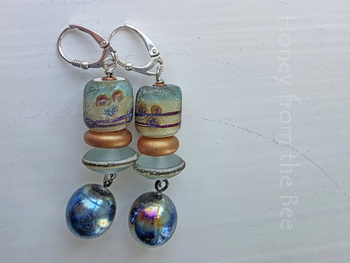 Teal and copper earrings feature lampwork