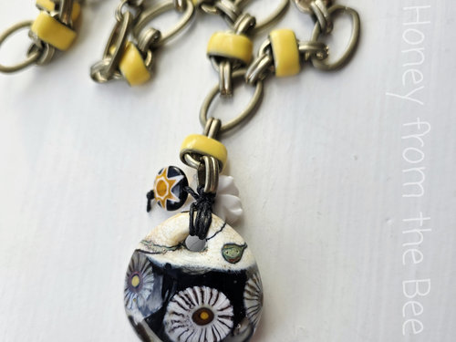 Daisy necklace features lampwork in black, white and yellow