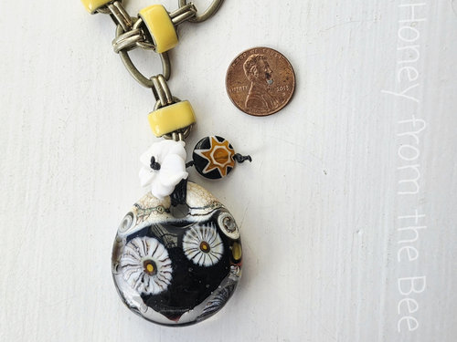 Floral necklace in black, yellow and white