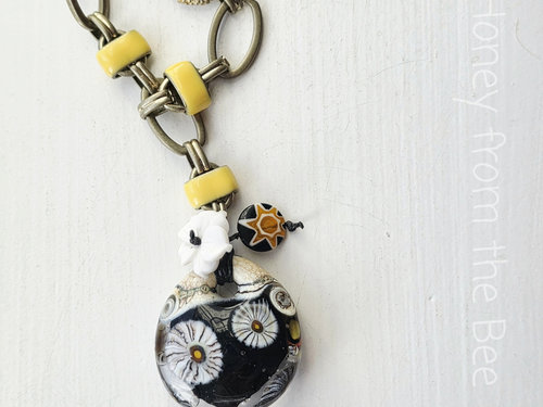 Statement necklace in black and yellow with daisy motif