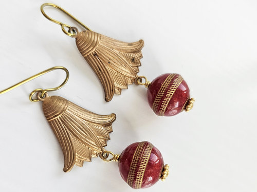 Red and gold colored earrings feature vintage components