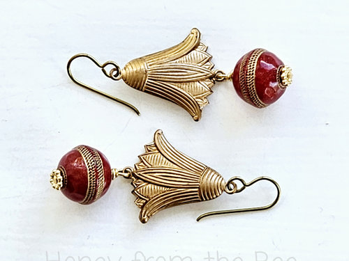 Dangle earrings feature vintage brass water lily and red lucite bead