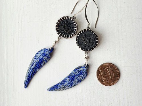 Blue and silver earrings feature lapis lazuli feather dangles and antique glass button