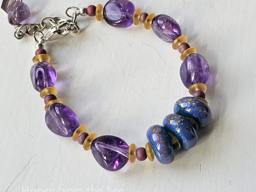 Amethyst bracelet with lampwork in shades of teal, purple and yellow