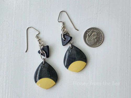 Lightweight artisan earrings feature drops made from a billiard ball