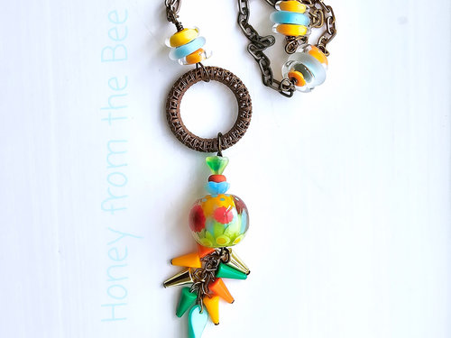 Tunic length necklace in an explosion of color