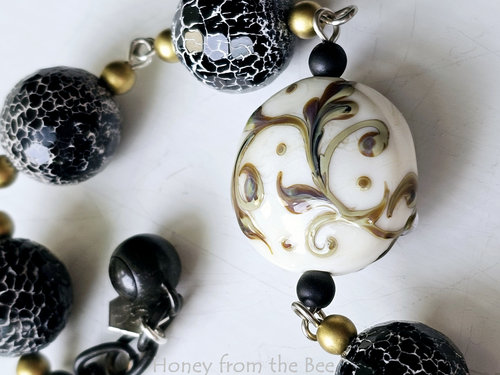 Statement bracelet in black and white with honeybee focal